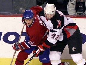 Montreal Canadien winger Brian Savage (left) battles for puck with Buffalo Sabre defenceman Richard Smehlik (42) on Nov. 3, 2000, at the HSBC Arena in Buffalo, N.Y. The Sudbury native was in town on the weekend for the Hometown Hockey festivities.