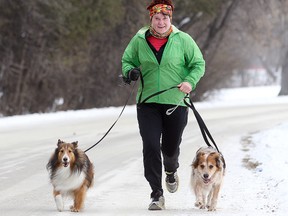 Cindy Luce takes advantage of the milder weather to run with her dogs Emma and Sam in Winnipeg, Man. Sunday December 07, 2014. (Brian Donogh/Winnipeg Sun/QMI Agency)