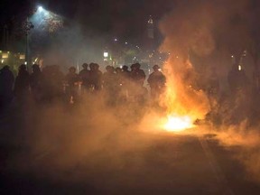 Police officers deploy teargas while trying to disperse a crowd comprised largely of student protesters during a protest against police violence in the U.S., in Berkeley, California early December 7, 2014. REUTERS/Noah Berger