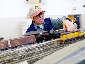 Allan Heard, of Brighton, adjusts a piece of the Brighton and Presqu'ile Model Railway Association's display at the 19th annual model railroad show in Belleville, Sunday, Dec. 7, 2014. - Emily Mountney-Lessard/The Intelligencer