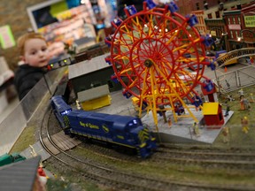 Two-year-old Preston Ellsworth, of Belleville, watches as a train rolls by on the Belleville Model Railroad Club's track, Sunday, Dec. 7, during the model railroad show in Belleville. Emily Mountney-Lessard/The Intelligencer