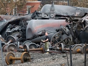 A police officer looks on near the site of the train wreckage in Lac-Megantic, in this July 9, 2013 file photo. (REUTERS/Mathieu Belanger/Files)