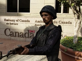 An Egyptian policeman stands guard outside the Canadian embassy in Cairo on December 8, 2014. (AFP PHOTO/AHMED SAYED)
