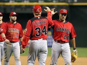 Tyson Gillies of Canada celebrates with coach Tim Leiper after defeating Mexico in the World Baseball Classic at Chase Field on March 9, 2013. (Christian Petersen/Getty Images/AFP)