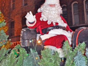 Santa waves to the crowd as he makes his way downtown. KRISTINE JEAN/MITCHELL ADVOCATE
