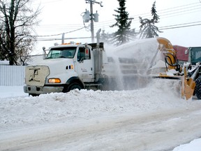 Snow maintenance crews were busy last week working on clean up from the first major snowfall to hit the area. ABOVE: Crews were on the job on 52 Ave. on Dec. 1.