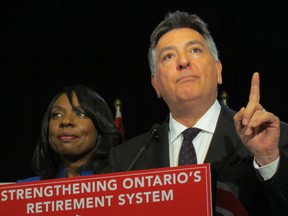 Ontario Finance Minister Charles Sousa and Associate Finance Minister Mitzie Hunter announce they are introducing new pension legislation on Monday Dec. 8, 2014. (ANTONELLA ARTUSO/Toronto Sun)