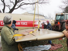 Sarnia's F86 Sabre Golden Hawk's wings were reattached Monday at Germain Park. The airplane is expected to go back on its pedestal later this week. TYLER KULA/ THE OBSERVER/ QMI AGENCY