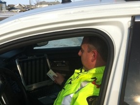 RCMP Const. Shawn Smith shows media how e-ticketing works at a press conference in Headingley. (RCMP PHOTO)