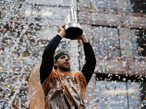 San Francisco Giants starting pitcher Madison Bumgarner (40) holds up his MVP trophy during the World Series victory parade on Market Street on Oct 31, 2014 in San Francisco, CA, USA. (Kelley L Cox/USA TODAY Sports)