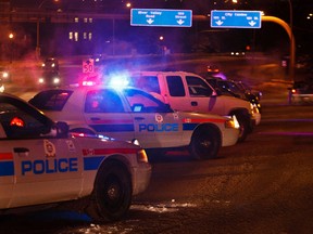 Edmonton Police Service members conduct a checkstop on the James MacDonald Bridge in Edmonton, Alta. on Thursday, Dec. 6, 2012. Codie McLachlan/Edmonton Sun