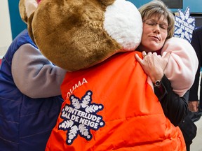 Shelly Glover, Minister of Canadian Heritage and Official Languages hugs a member of the Ice Hog family following a press conference where the program for the 37th Winterlude was announced in Ottawa on Monday December 8, 2014. 
Errol McGihon/Ottawa Sun/QMI Agency