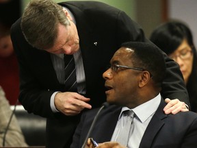 Mayor John Tory speaks with Councillor Michael Thompson at the executive committee meeting at City Hall in Toronto on Friday, December 5, 2014. (Craig Robertson/Toronto Sun)
