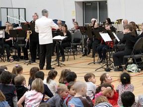 Band leader Chris Alfano conducts as members of the La Salle Community Concert Band perform at Ecole Madeleine-de-Roybon on Monday. (Ian MacAlpine/The Whig-Standard)