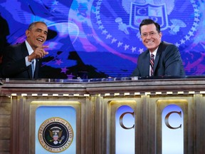 U.S. President Barack Obama, left, appears on The Colbert Report with Stephen Colbert at the Lisner Auditorium at George Washington University in Washington on December 8,  2014. (REUTERS/Kevin Lamarque)
