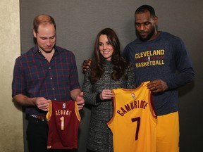 Prince William, Duke of Cambridge and Catherine, Duchess of Cambridge pose with LeBron James (R) as they attend the Cleveland Cavaliers vs. Brooklyn Nets game at Barclays Center on December 8, 2014 in the Brooklyn borough of New York City. (Neilson Barnard/Getty Images/AFP)