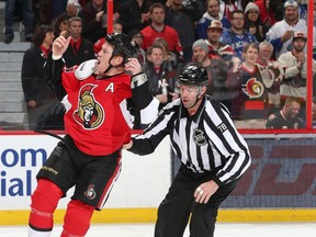 Linesman Brian Mach  steers Chris Neil #25 of the Ottawa Senators to the penalty box as he tries to get the fans going following a fight in the second period against the Vancouver Canucks during an NHL game at Canadian Tire Centre on December 7.  Jana Chytilova/Freestyle Photography/Getty Images/AFP