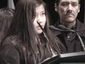 Rinelle Harper, 16, speaks as her father Caesar watches at RBC Convention Centre in Winnipeg during an Assembly of First Nations conference on Dec. 9, 2014. Harper, who was raped and left for dead in November, spoke in favour of an inquiry into missing and murdered indigenous women. (JIM BENDER/WINNIPEG SUN)