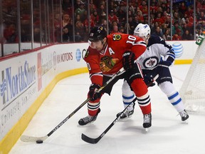 Chicago Blackhawks left wing Patrick Sharp (10) skates with the puck against Winnipeg Jets defenseman Jacob Trouba (8) during the third period at United Center on Nov 2, 2014. Mike DiNovo-USA TODAY Sports