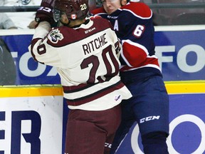 Peterborough Petes' Nick Ritchie collides with Saginaw Spirit's Ryan Orban during first period OHL action on Thursday, October 23, 2014 at the Memorial Centre in Peterborough. Clifford Skarstedt/Peterborough Examiner/QMI Agency