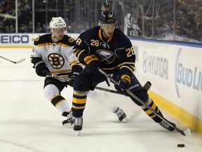 Buffalo Sabres center Zemgus Girgensons (28) and Boston Bruins center Carl Soderberg (34) go after a loose puck during the second period at First Niagara Center. (Timothy T. Ludwig-USA TODAY Sports)