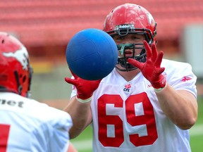 Calgary Stampeders centre Brett Jones trains with his teammates during training camp at McMahon Stadium in Calgary, Alta on Friday, May 31, 2013. (QMI Agency file photo)