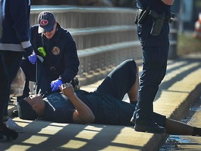 A Charlotte firefighter tends to Carolina Panthers quarterback Cam Newton following a crash in uptown Charlotte, N.C., December 9, 2014. (REUTERS/Todd Sumlin/Charlotte Observer/TNS)