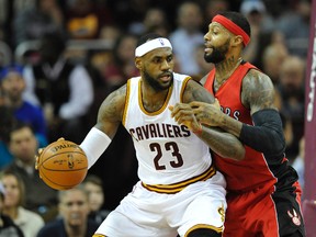 Cavaliers forward LeBron James (left) dribbles the ball as the Raptors forward James Johnson defends in the second quarter at Quicken Loans Arena in Cleveland on Tuesday. (David Richard-USA TODAY Sports)