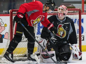 Ottawa Senators Clarke MacArthur brushes snow off of goaltender Robin Lehner after spraying him during team practice at the Canadian Tire Centre in Ottawa on Tuesday December 9, 2014. Errol McGihon/Ottawa Sun/QMI Agency