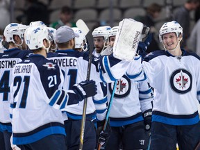 Dec 9, 2014; Dallas, TX, USA; The Winnipeg Jets celebrate the win over the Dallas Stars at the American Airlines Center. The Jets defeated the Stars 5-2. Mandatory Credit: Jerome Miron-USA TODAY Sports