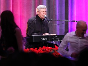 Prime Minister Stephen Harper performs with the band the Van Cats during the Conservative caucus Christmas party in Ottawa on December 9, 2014. (REUTERS/Chris Wattie)