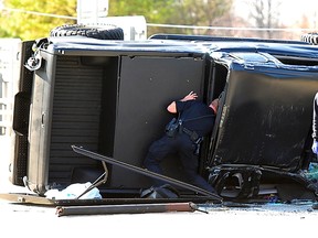 Police and fire officials examine Carolina Panthers quarterback Cam Newton's damaged truck following a crash in uptown Charlotte, North Carolina, December 9, 2014. (REUTERS)