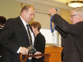 New Huron County Warden Paul Gowing, Mayor for Morris-Turnberry, is presented with the warden’s collar by Joe Steffler, who held the post during 2014. (DAVE FLAHERTY/GODERICH SIGNAL STAR)