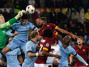 Manchester City goalkeeper Joe Hart (left) makes a save during their Champions League match against AS Roma at the Olympic stadium in Rome December 10, 2014. (REUTERS/Max Rossi)