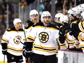 Simon Gagne #12 of the Boston Bruins celebrates his goal with the bench to trail 3-2 to the Anaheim Ducks during the third period at Honda Center on December 1, 2014 in Anaheim, California. (Harry How/Getty Images/AFP)