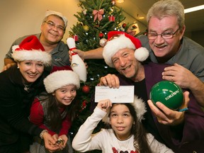 Bowlerama crew donate $2,015 to Mike Strobel's Christmas Fund for Variety Village on Wednesday, December 10, 2014 at the Toronto Sun. From left, Super Elf Christina Fleming, Bowlerama's George Houshan, Laila, Natalie, Danny DeFrancesco, and Mike Strobel. (Stan Behal/Toronto Sun)