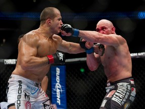 Shane Carwin (right) lands a punch on Junior Dos Santos during their fight at UFC 131 at Rogers Arena in Vancouver, BC, June, 11, 2011. (RICHARD LAM/QMI Agency)