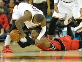 Cavaliers guard Kyrie Irving and Raptors forward Terrence Ross battle for the ball on Tuesday. The Raptors went to the free throw line only 10 times in the 105-101 loss, opposed to the Cavaliers’ 21 attempts. (USA TODAY)