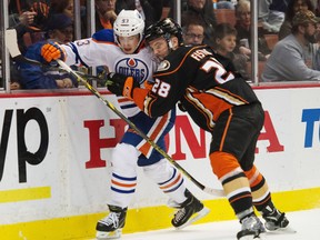 Ryan Nugent-Hopkins tangles with Ducks defenceman Mark Fistric during second-period action Wednesday, Dec. 10, 2014,  in Anaheim. (USA TODAY SPORTS)