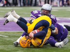 Western Mustangs defensive lineman Daryl Waud, seen here sacking Queen's Golden Gaels QB Billy McPhee, is third in the latest CFL draft rankings. (Craig Glover, QMI Agency)