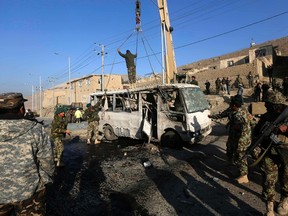 Afghan National Army soldiers (ANA) inspect the site of a suicide attack in Kabul on December 11, 2014. (REUTERS/Omar Sobhani)