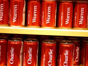 Commemorative Coca Cola cans featuring the names of Berkshire Hathway CEO Warren Buffett and vice-chairman Charlie Munger are seen at the exhibition of Berkshire Hathaway companies at the annual meeting in Omaha, Nebraska May 3, 2014.  REUTERS/Rick Wilking
