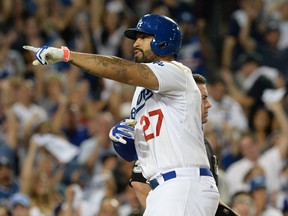 Los Angeles Dodgers left fielder Matt Kemp (27) reacts after hitting a solo home run in the eighth inning against the St. Louis Cardinals in game two of the 2014 NLDS playoff baseball game at Dodger Stadium. (Jayne Kamin-Oncea-USA TODAY Sports)