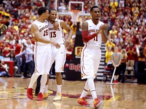 Naz Long #15, Bryce Dejean-Jones #13, and Monte Morris #11 of the Iowa State Cyclones celebrate a mid court during a time out in the last minutes of the second half of play against the Arkansas Razorbacks at Hilton Coliseum on December 4, 2014 in Ames, Iowa. (David Purdy/Getty Images/AFP)
