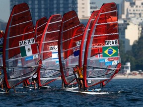 Competitors stand on their windsurfing boards at the women's RS-X sailing class during the first test event for the Rio 2016 Olympic Games at the Guanabara Bay in Rio de Janeiro August 3, 2014. (REUTERS)