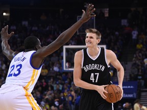 Brooklyn Nets forward Andrei Kirilenko (47) controls the basketball against Golden State Warriors forward Draymond Green (23) during the first quarter at Oracle Arena on November 13, 2014 in Oakland, CA, USA. (Kyle Terada/USA TODAY Sports)