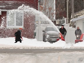 Ottawa residents dig out after a snow storm on Thursday, Dec. 11,  2014. Ottawa saw up to 20 cm of snow Wednesday and through the early-morning hours of Thursday.  Tony Caldwell/Ottawa Sun/QMI Agency
