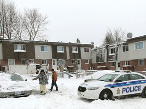 Ottawa Police were back on Penny Drive in Ottawa Thursday, Dec, 11,  2014, investigating a bullet hole in a car window.  Tony Caldwell/Ottawa Sun/QMI Agency