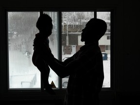 Bullet holes in the window of a Penny Drive on Thursday Dec 11,  2014.  Gun fire in November caused the bullet holes in the windows of Rosmann Augustin's house. Rosmann and his child stand in front of the window where the bullets entered his house in November.  
Tony Caldwell/Ottawa Sun/QMI Agency
