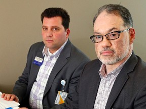 Quinte Health Care vice-president Jeff Hohenkerk, foreground, and human resources director Mitch Birken sit in Hohenkerk's office in Belleville General Hospital Thursday. They say patients won't notice a change in service in the first round of restructuring for 2015-2016 and the goal is to have no involuntary departures of staff. Luke Hendry/The Intelligencer